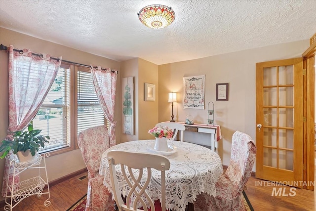 1460 Fairway Ct, Mountain Home, ID 83647 - dining space with wood finished floors and a textured ceiling