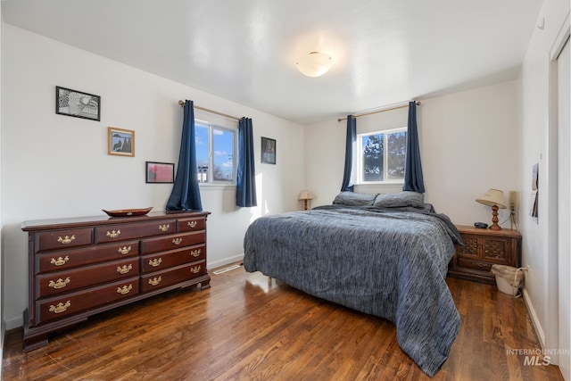 bedroom with dark wood-type flooring