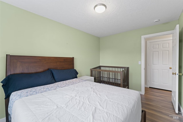 5509 Aspenwood Ave, Caldwell, ID 83607 - bedroom featuring wood finished floors and a textured ceiling