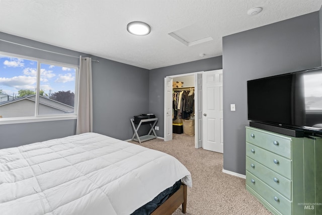 5509 Aspenwood Ave, Caldwell, ID 83607 - bedroom featuring attic access, light colored carpet, a spacious closet, a closet, and a textured ceiling