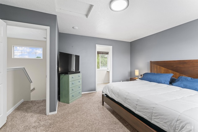 5509 Aspenwood Ave, Caldwell, ID 83607 - bedroom featuring attic access, light carpet, and a textured ceiling