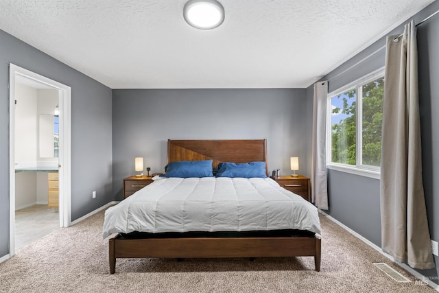 5509 Aspenwood Ave, Caldwell, ID 83607 - carpeted bedroom with a textured ceiling and ensuite bath
