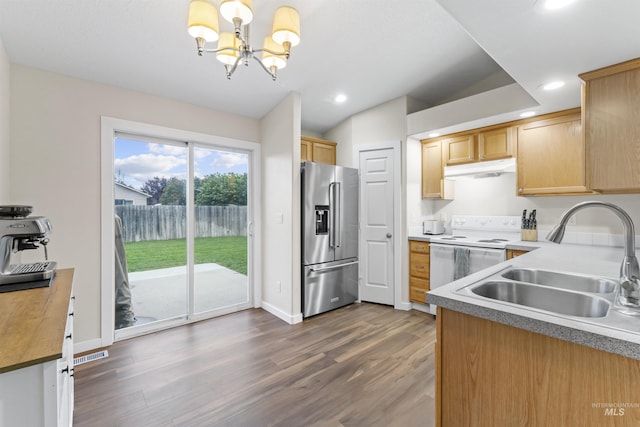 5509 Aspenwood Ave, Caldwell, ID 83607 - kitchen featuring high end fridge, white range with electric cooktop, under cabinet range hood, a chandelier, and recessed lighting