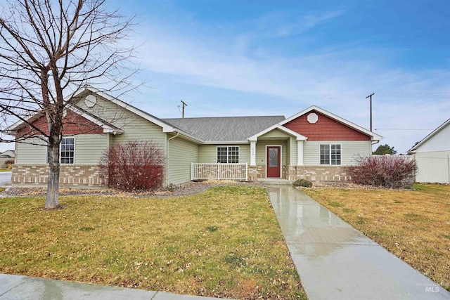 single story home featuring fence, a front lawn, and brick siding