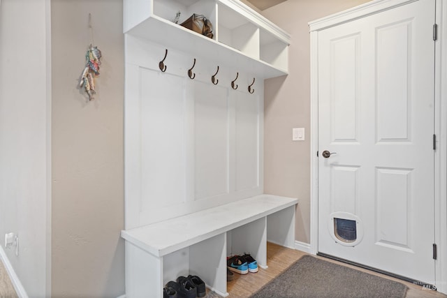 mudroom with light wood-style floors and baseboards