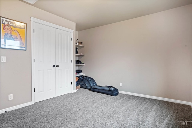 bedroom with a closet, carpet, and baseboards