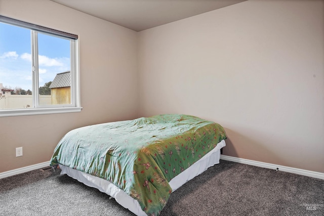 carpeted bedroom featuring baseboards