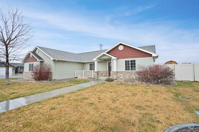 view of front of property with a front lawn and fence