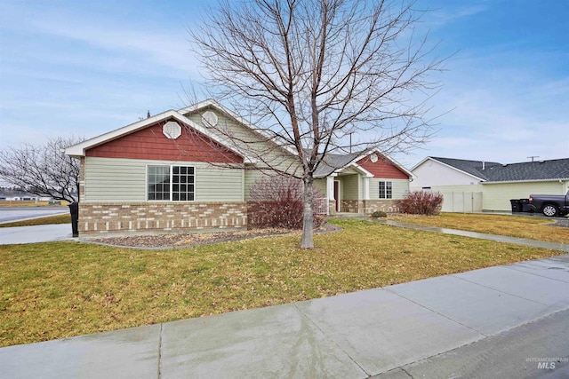 view of front of property featuring brick siding and a front lawn