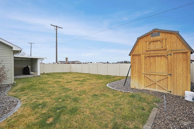 view of yard featuring a storage shed, fence, and an outbuilding