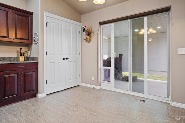 entryway with light wood-type flooring, baseboards, and visible vents