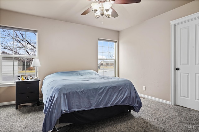 carpeted bedroom with a ceiling fan and baseboards