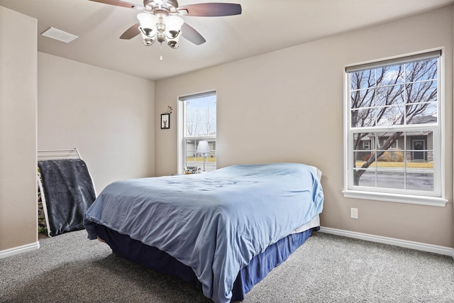 bedroom with a ceiling fan, carpet, visible vents, and baseboards