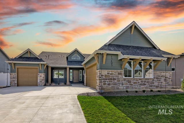 view of front of home with an attached garage, roof with shingles, concrete driveway, and stone siding