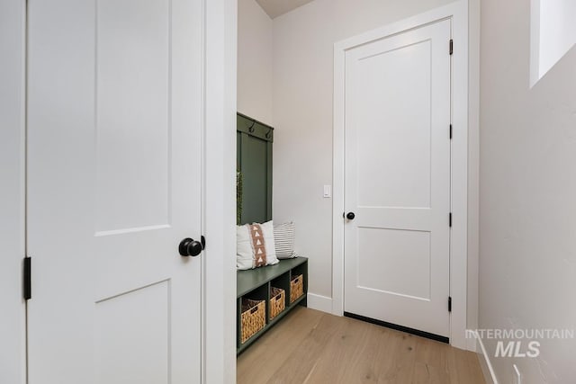 mudroom with light wood-style flooring and baseboards