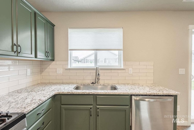 7666 E Lightfoot St, Nampa, ID 83687 - kitchen featuring a sink, stainless steel appliances, green cabinetry, and decorative backsplash