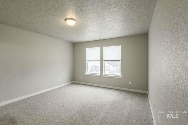 7666 E Lightfoot St, Nampa, ID 83687 - spare room with carpet, baseboards, a textured ceiling, and a textured wall
