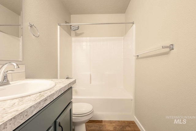 7666 E Lightfoot St, Nampa, ID 83687 - full bath with toilet, wood finished floors, a textured wall, vanity, and shower / washtub combination