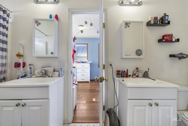 706 Utah St, Gooding, ID 83330 - full bath featuring vanity, wood finished floors, and toilet
