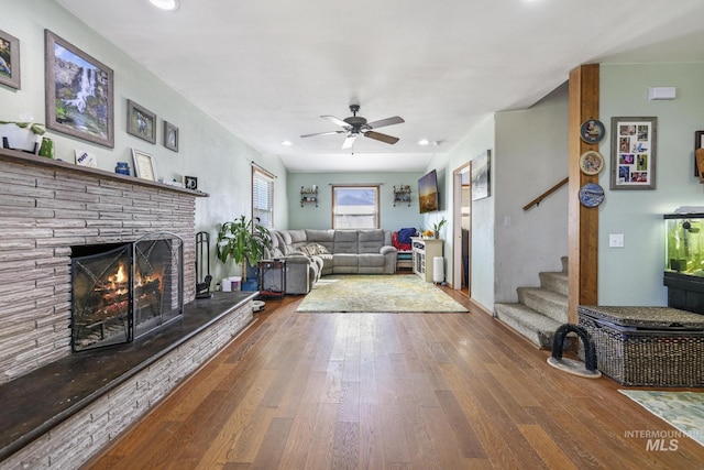 706 Utah St, Gooding, ID 83330 - living room featuring wood finished floors, a ceiling fan, stairway, a lit fireplace, and recessed lighting