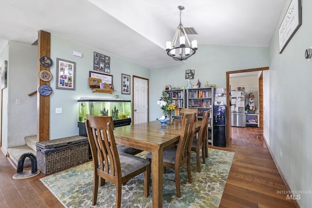 706 Utah St, Gooding, ID 83330 - dining area featuring a chandelier, wood finished floors, and vaulted ceiling
