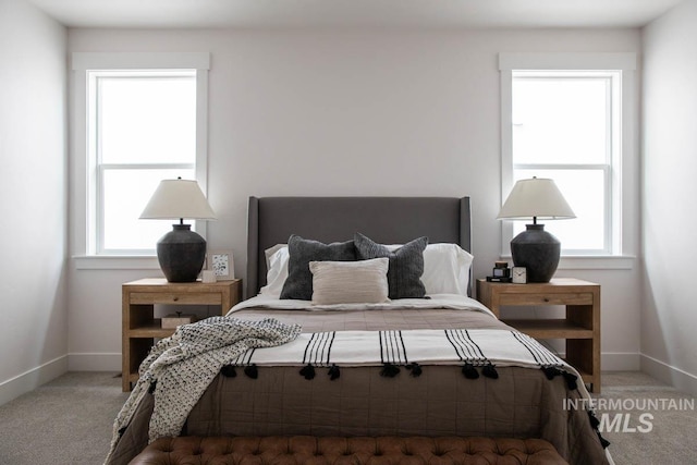 carpeted bedroom featuring baseboards