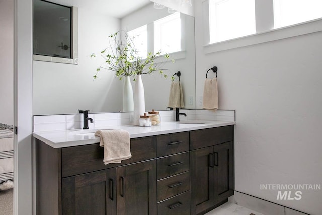 full bath featuring double vanity and a sink