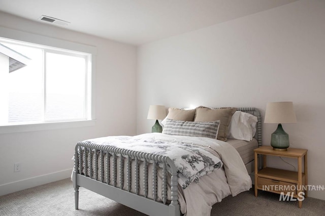 bedroom with baseboards, visible vents, and carpet flooring