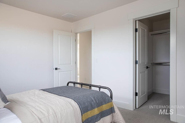 bedroom featuring a closet, carpet flooring, and baseboards