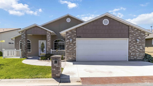 421 N David Frost St, Nampa, ID 83651 - single story home with concrete driveway, a porch, a front yard, a garage, and brick siding