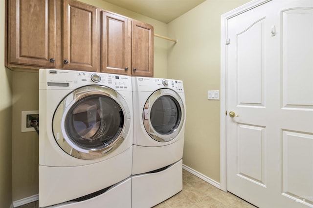 421 N David Frost St, Nampa, ID 83651 - laundry room featuring cabinet space, washing machine and clothes dryer, baseboards, and light tile patterned flooring