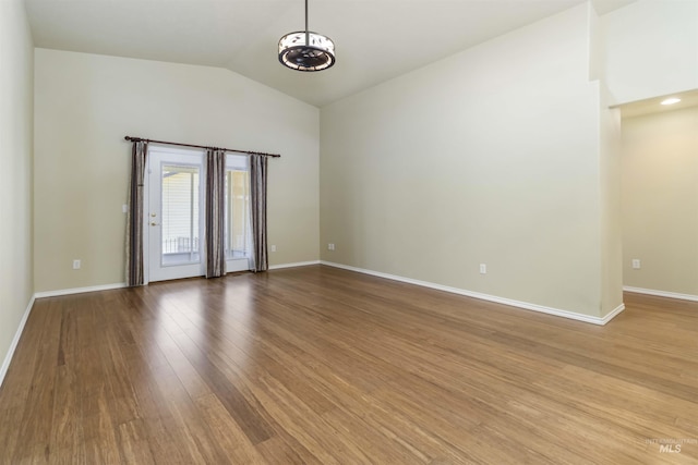 421 N David Frost St, Nampa, ID 83651 - unfurnished room featuring vaulted ceiling, wood finished floors, baseboards, and a chandelier