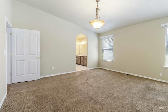 421 N David Frost St, Nampa, ID 83651 - empty room featuring light carpet, arched walkways, and baseboards