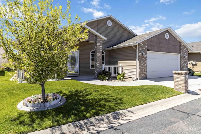 421 N David Frost St, Nampa, ID 83651 - view of front of house featuring a garage, a front lawn, concrete driveway, and brick siding