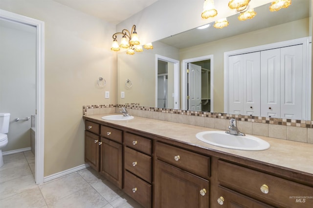 421 N David Frost St, Nampa, ID 83651 - full bath with a chandelier, toilet, double vanity, tile patterned flooring, and decorative backsplash