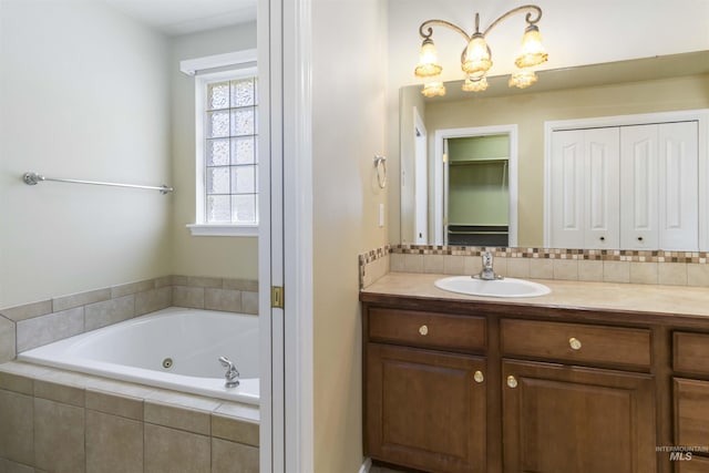 421 N David Frost St, Nampa, ID 83651 - bathroom featuring a tub with jets, vanity, backsplash, and a closet