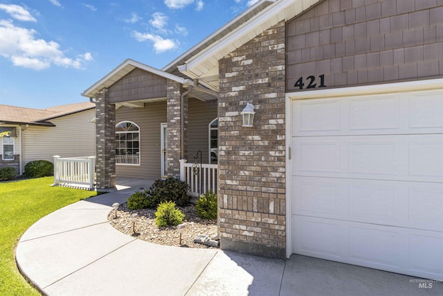 421 N David Frost St, Nampa, ID 83651 - view of exterior entry featuring a garage and a lawn