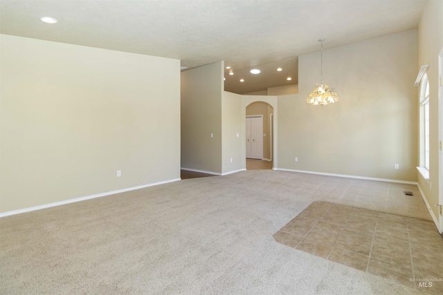 421 N David Frost St, Nampa, ID 83651 - empty room with a chandelier, arched walkways, carpet floors, recessed lighting, and vaulted ceiling