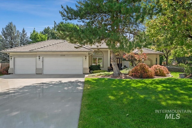 2368 SE 5th Way, Meridian, ID 83642 - view of front facade with an attached garage, driveway, a tile roof, and stucco siding