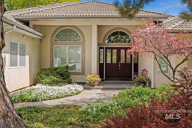2368 SE 5th Way, Meridian, ID 83642 - entrance to property with a tiled roof, stucco siding, and covered porch