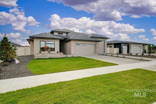 prairie-style house featuring a garage and a front yard