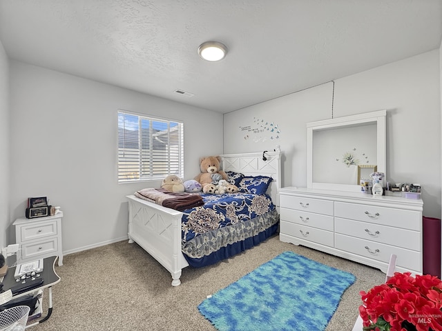 bedroom with baseboards, a textured ceiling, visible vents, and carpet flooring