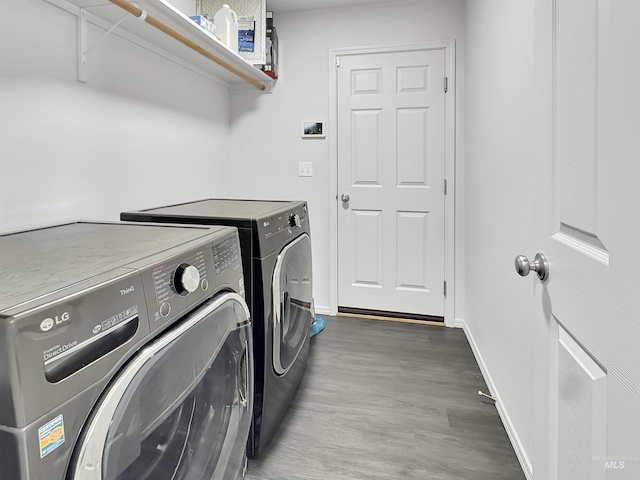 laundry room with laundry area, baseboards, wood finished floors, and independent washer and dryer