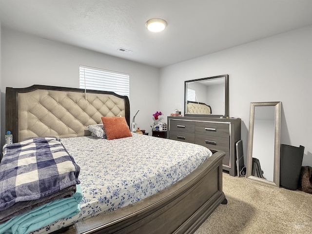 bedroom with visible vents and light colored carpet