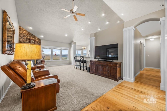 160 Summit Ridge Rd, Horseshoe Bend, ID 83629 - living area with decorative columns, ceiling fan, arched walkways, baseboards, and a textured ceiling