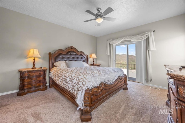 160 Summit Ridge Rd, Horseshoe Bend, ID 83629 - bedroom featuring access to exterior, carpet, a textured ceiling, baseboards, and ceiling fan