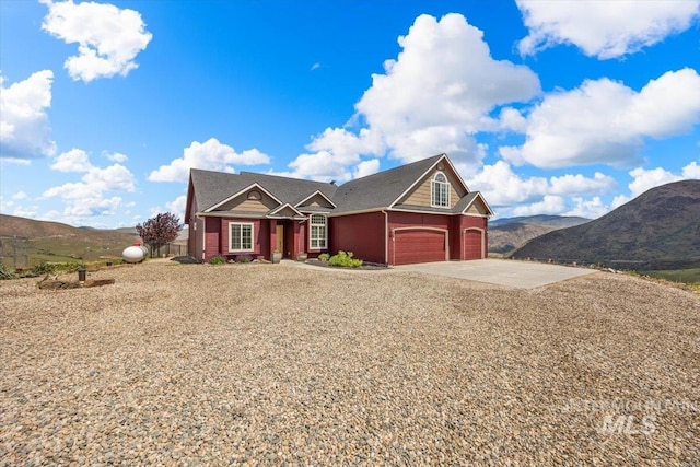 160 Summit Ridge Rd, Horseshoe Bend, ID 83629 - view of front facade featuring a garage, concrete driveway, and a mountain view