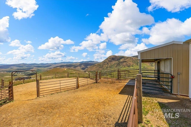 160 Summit Ridge Rd, Horseshoe Bend, ID 83629 - view of yard with a mountain view, an exterior structure, a view of rural / pastoral area, and an enclosed riding area