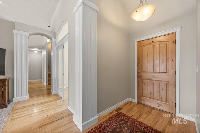 160 Summit Ridge Rd, Horseshoe Bend, ID 83629 - entryway featuring vaulted ceiling, arched walkways, wood finished floors, and baseboards