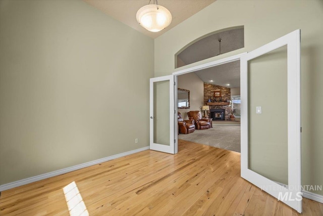160 Summit Ridge Rd, Horseshoe Bend, ID 83629 - spare room featuring hardwood / wood-style flooring, high vaulted ceiling, baseboards, and french doors